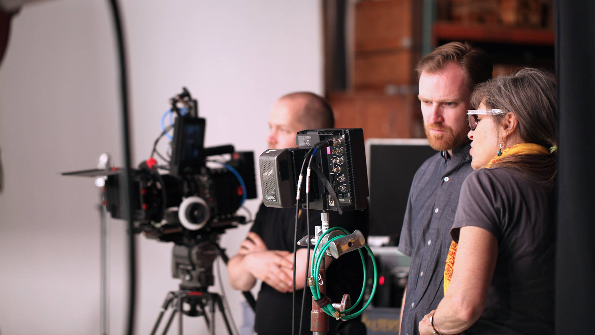 VFX course poster for VFX Supervision showing a VFX supervisor standing next to a camera talking to the director of photography.